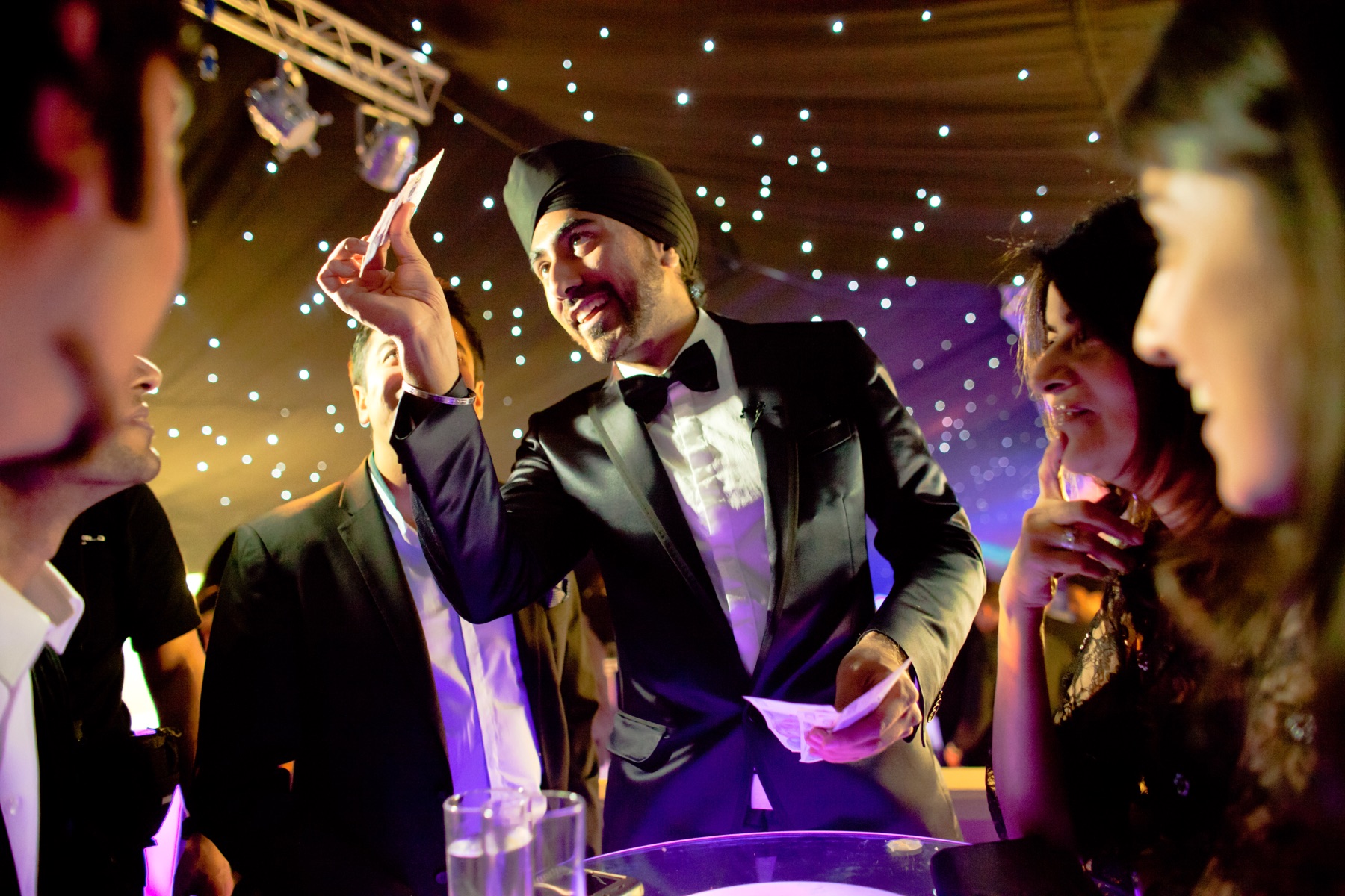 Magic Singh performing close-up magic at an evening event