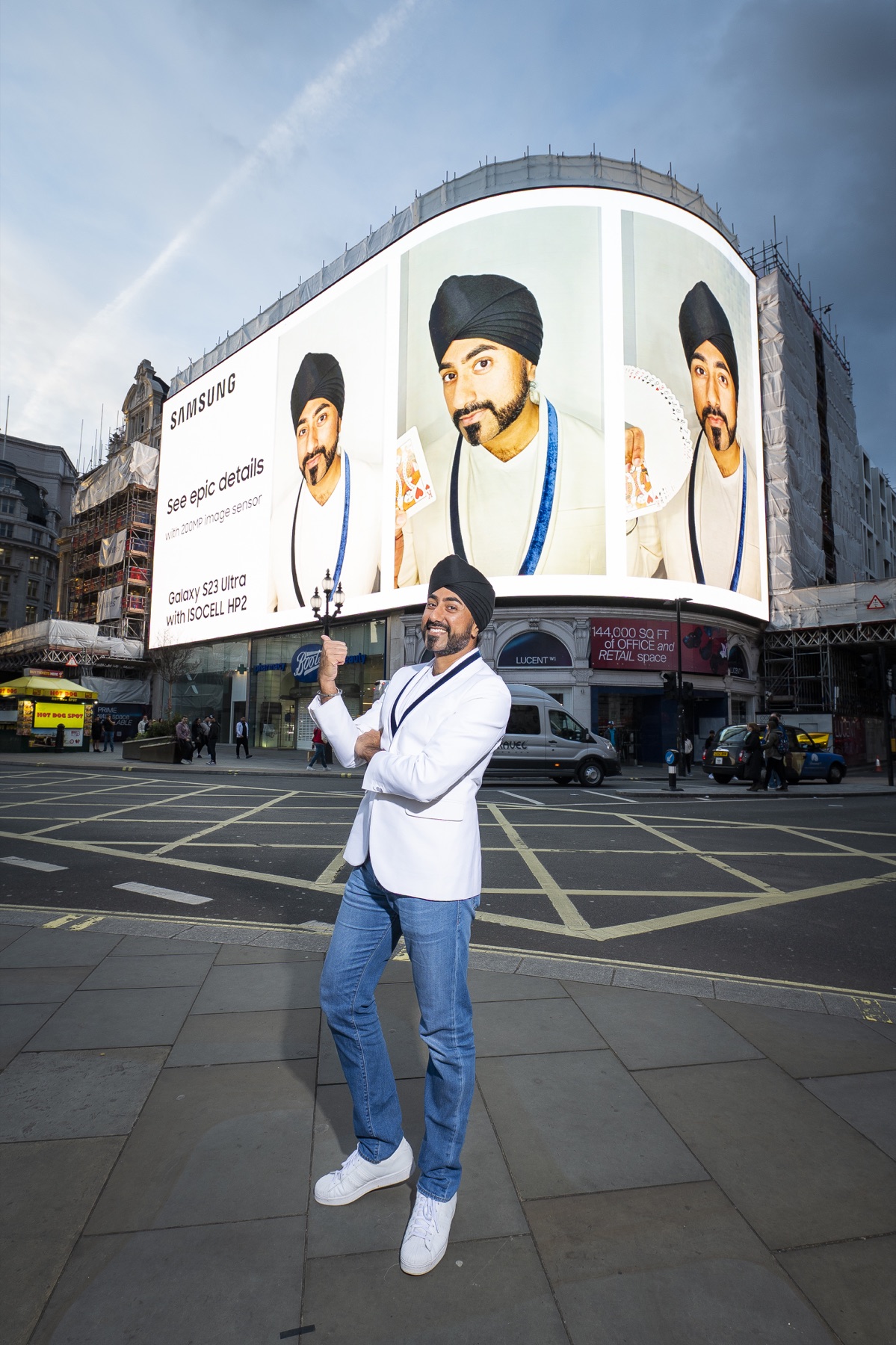 Magic Singh in front of his Samsung campaign at Piccadilly Circus